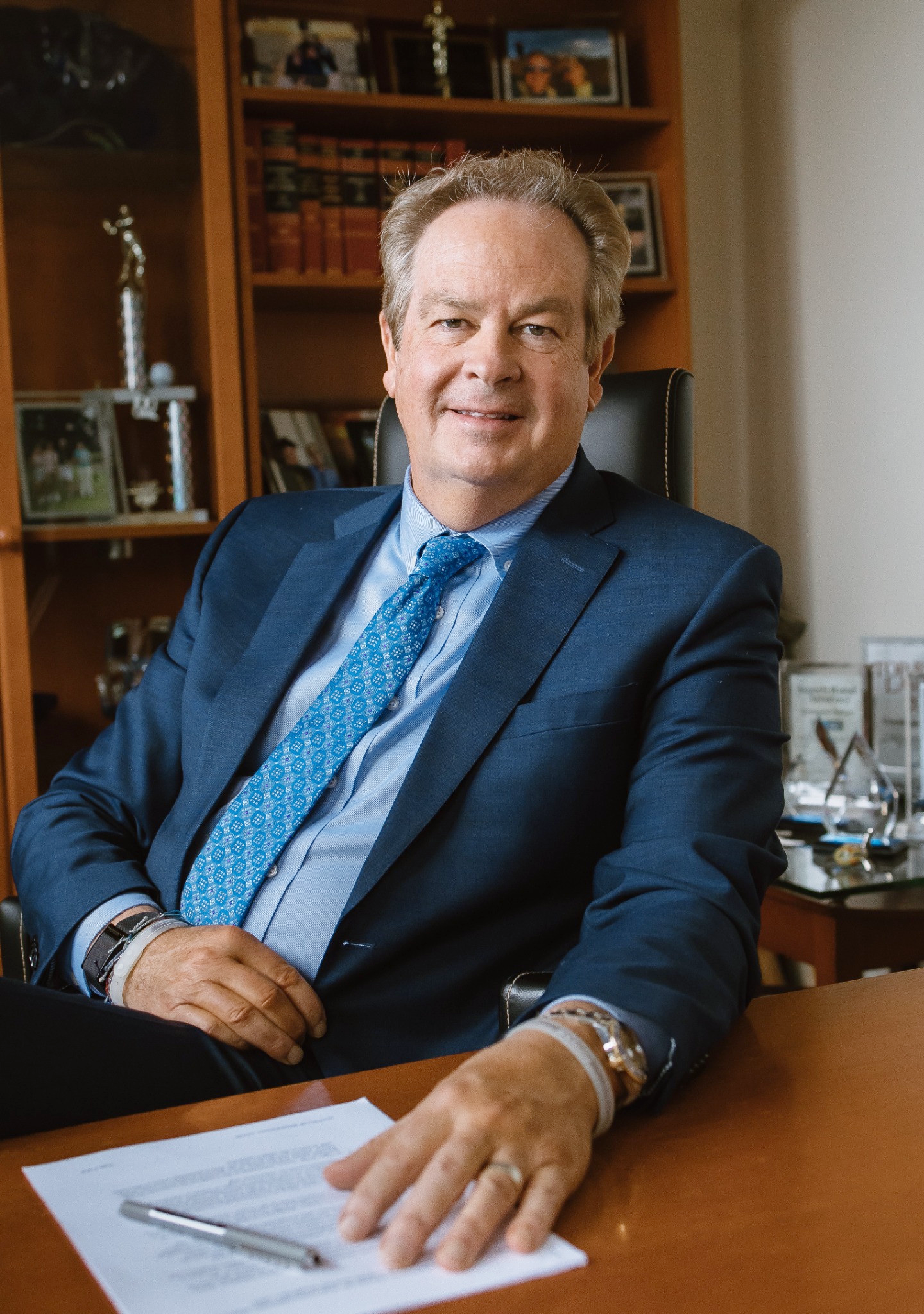 Chris seated at his office desk